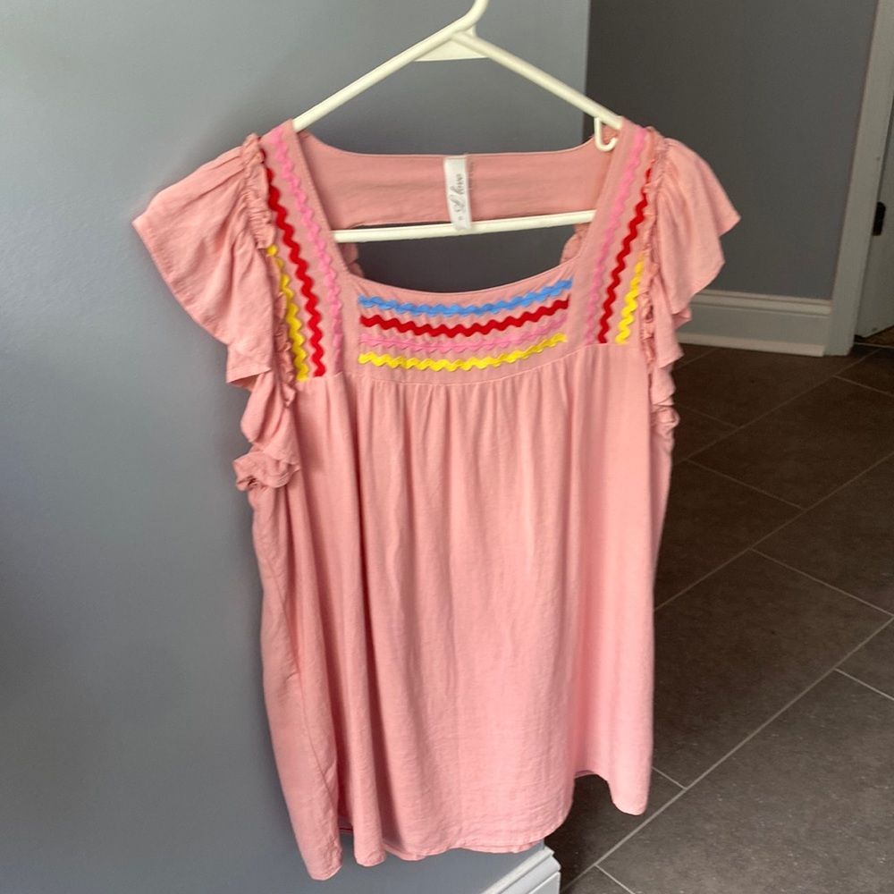 Pink flutter sleeve top with rick rack detail